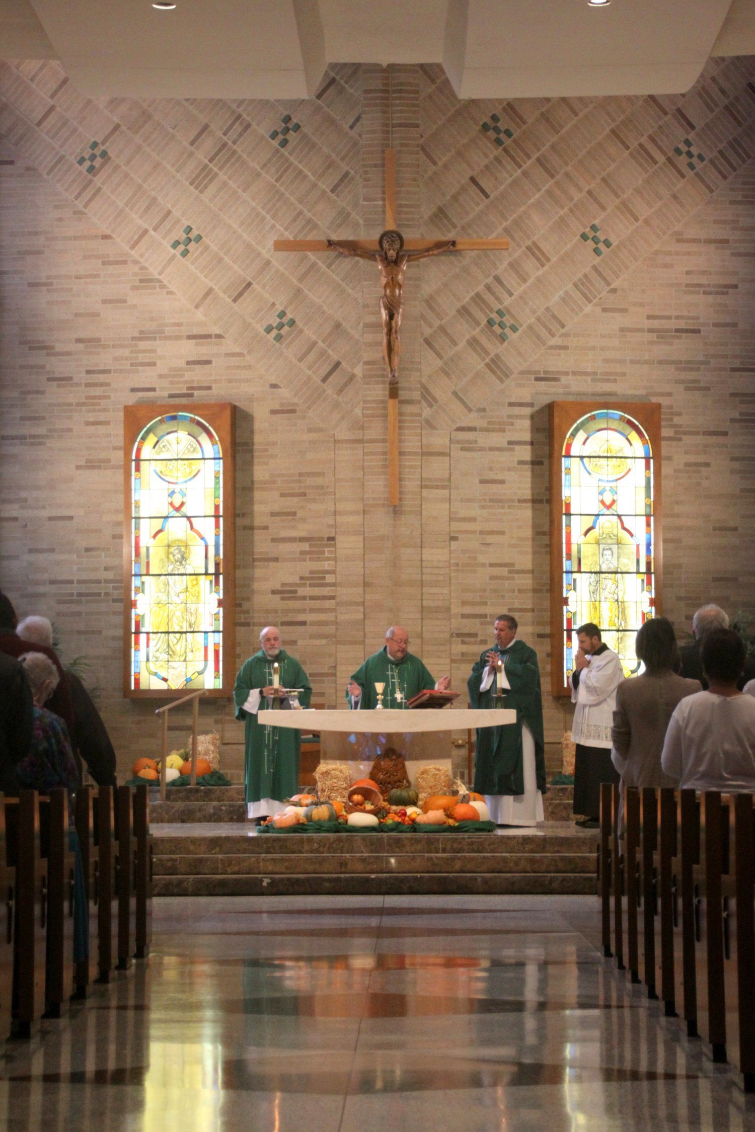 A group of priests are standing in front of an altar in a church.