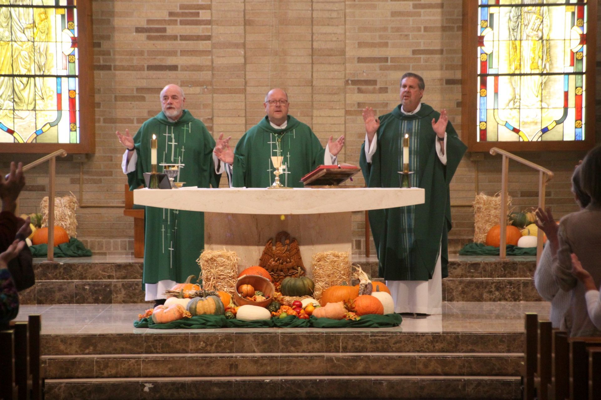 A group of priests are standing at an altar in a church.