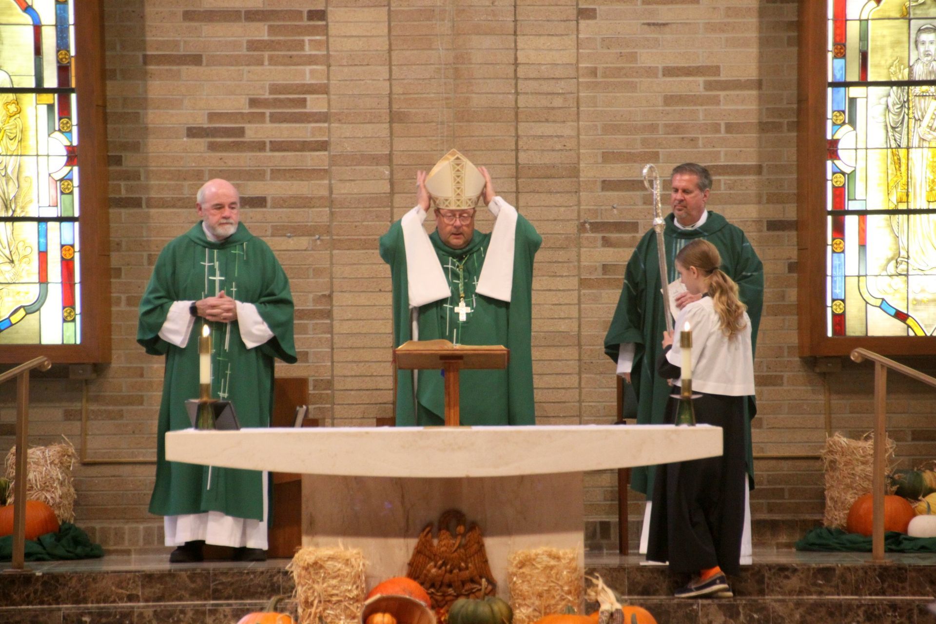 A group of priests are standing around an altar in a church.