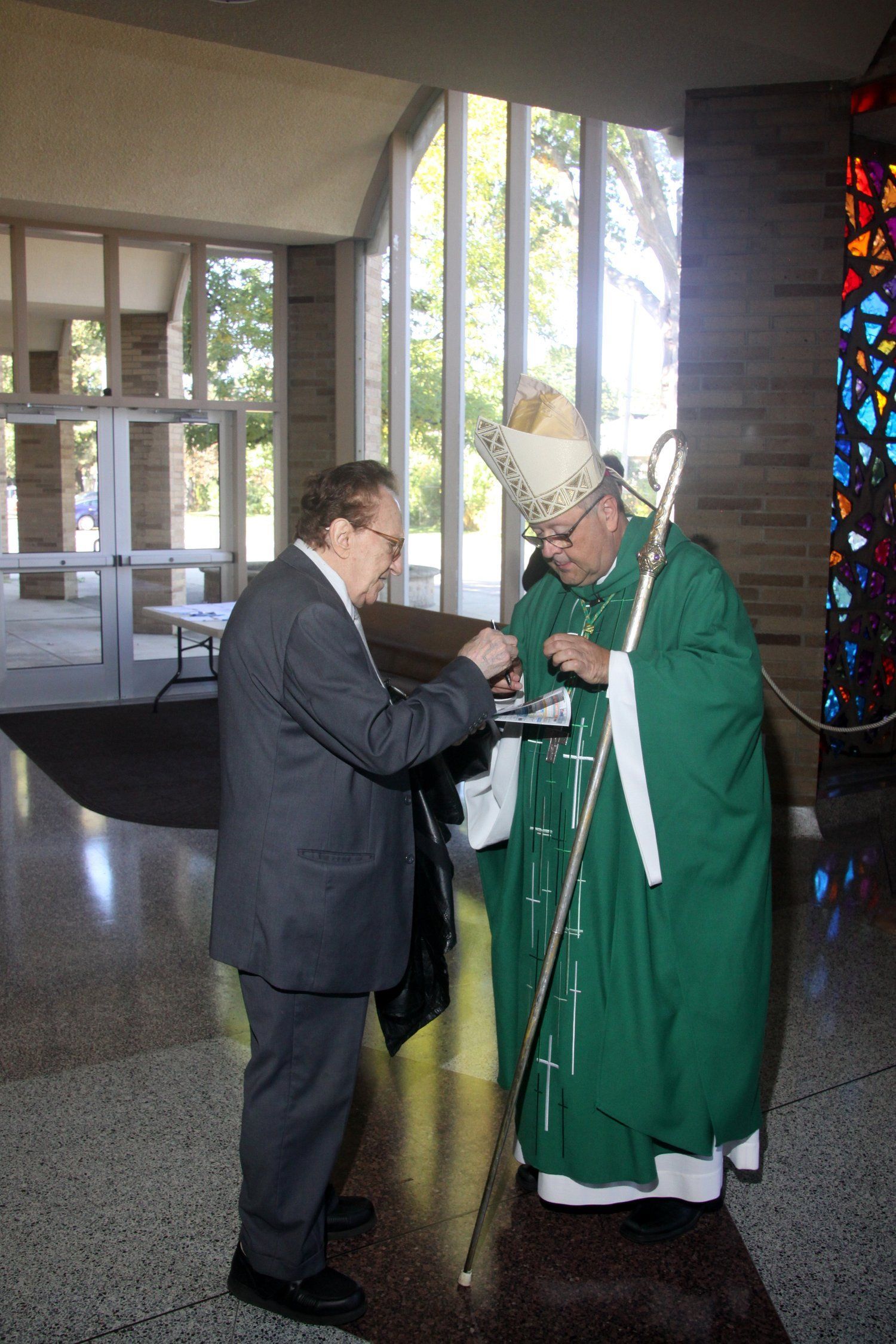 the bishop speaks to a parishioner 