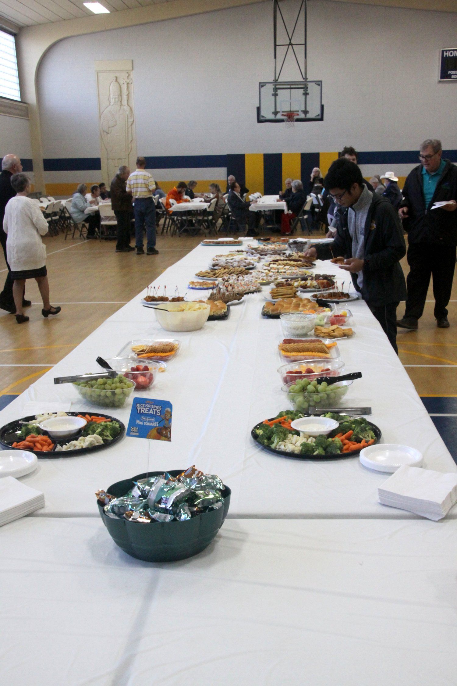 A long table with lots of food on it in a gym