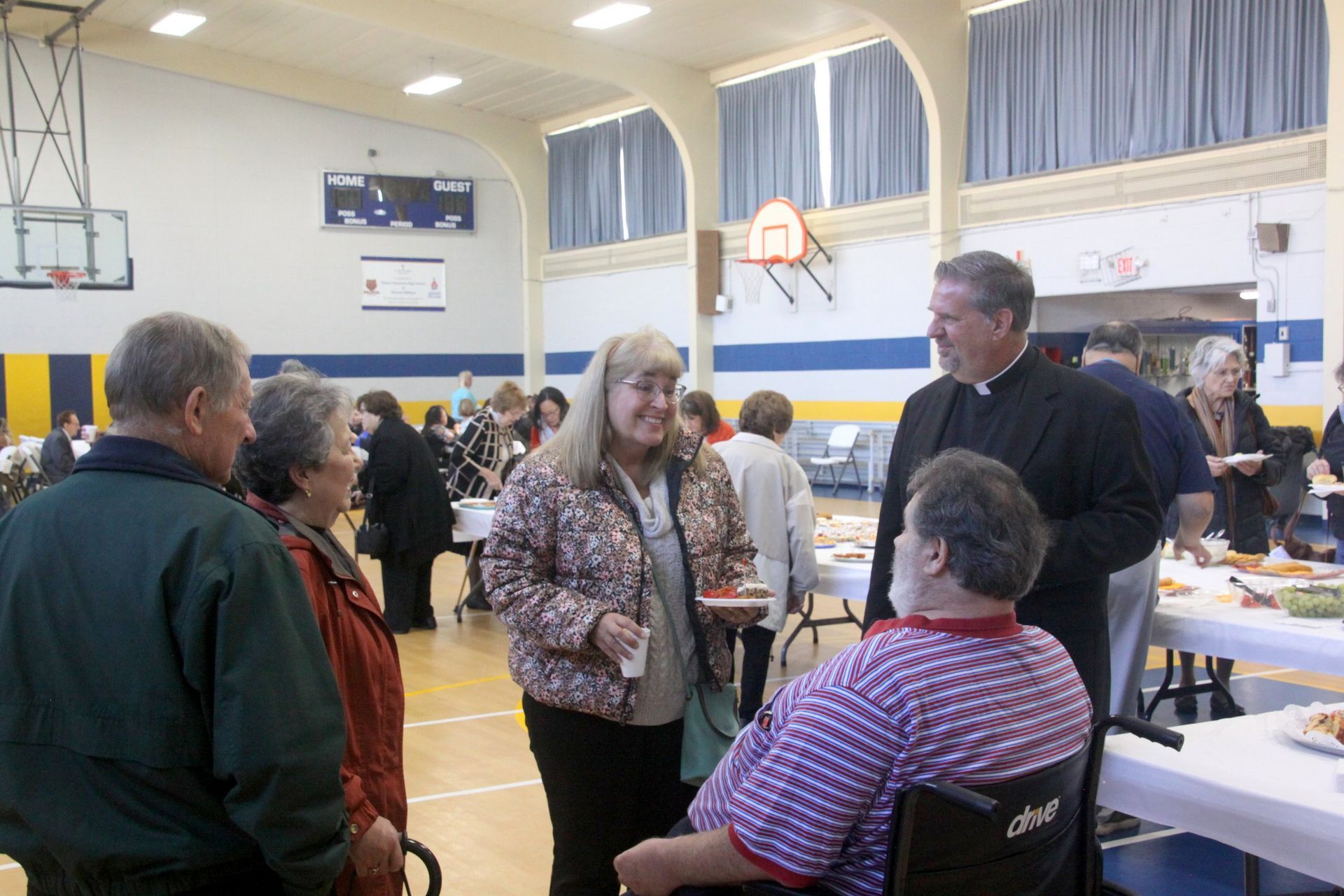 A man in a wheelchair is talking to a group of people
