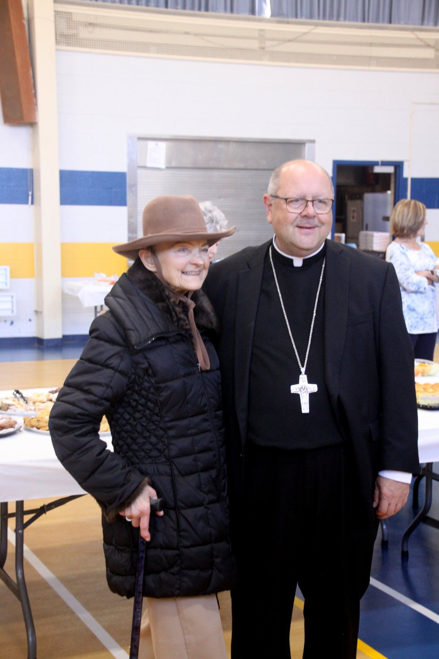 A man and a woman are posing for a picture in a gym