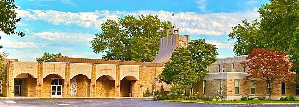 church exterior with trees in front of it.