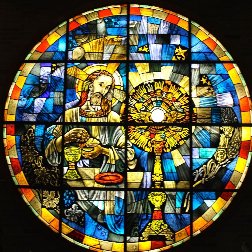 A stained-glass window shows the eucharist
