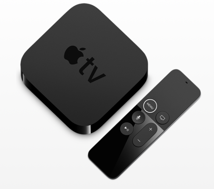 An apple tv box next to a remote control