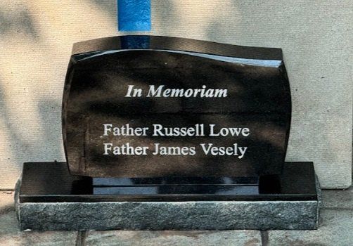 A gravestone for father russell lowe and father james vesely