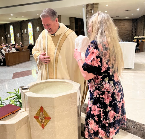 a woman is being baptized