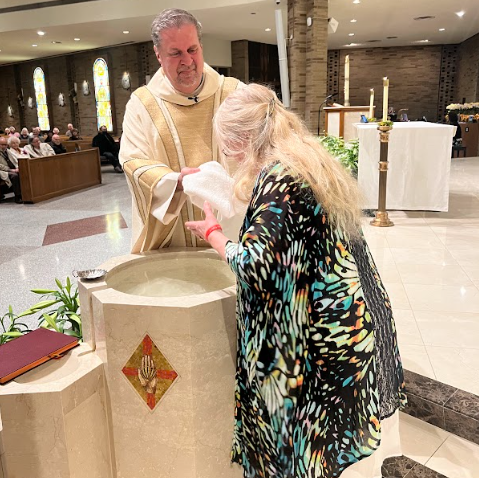 A man is baptising a woman in a church.