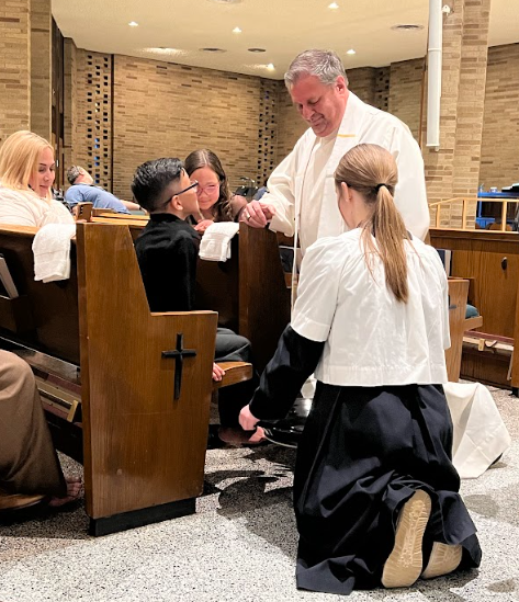 A group of people are kneeling down in a church