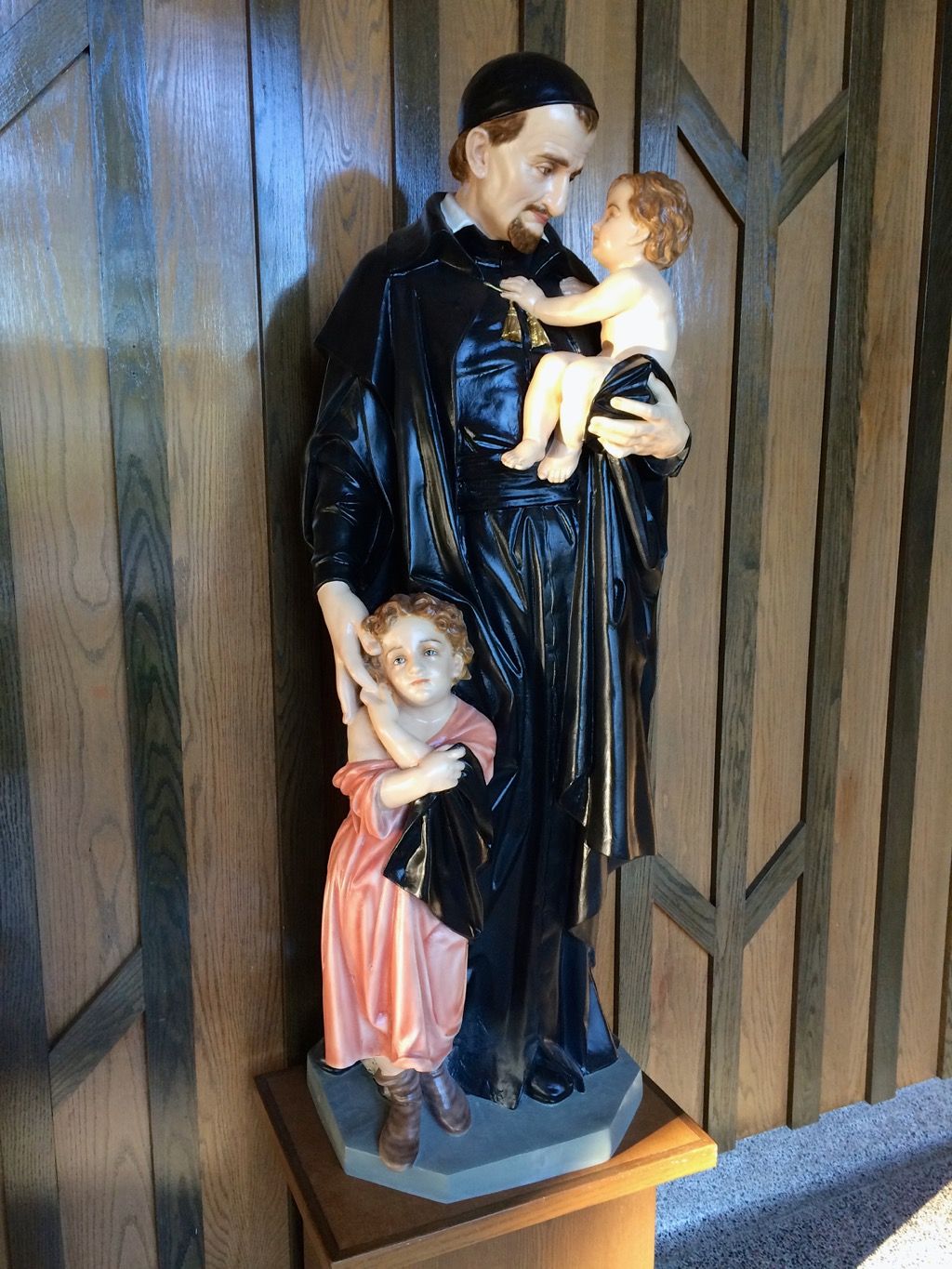 A statue of St. Vincent de Paul holding two children in his arms