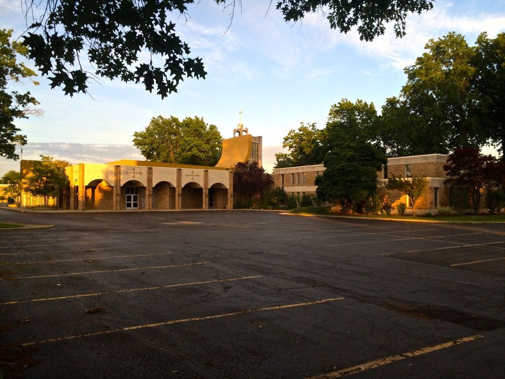 An empty parking lot with the church in the background