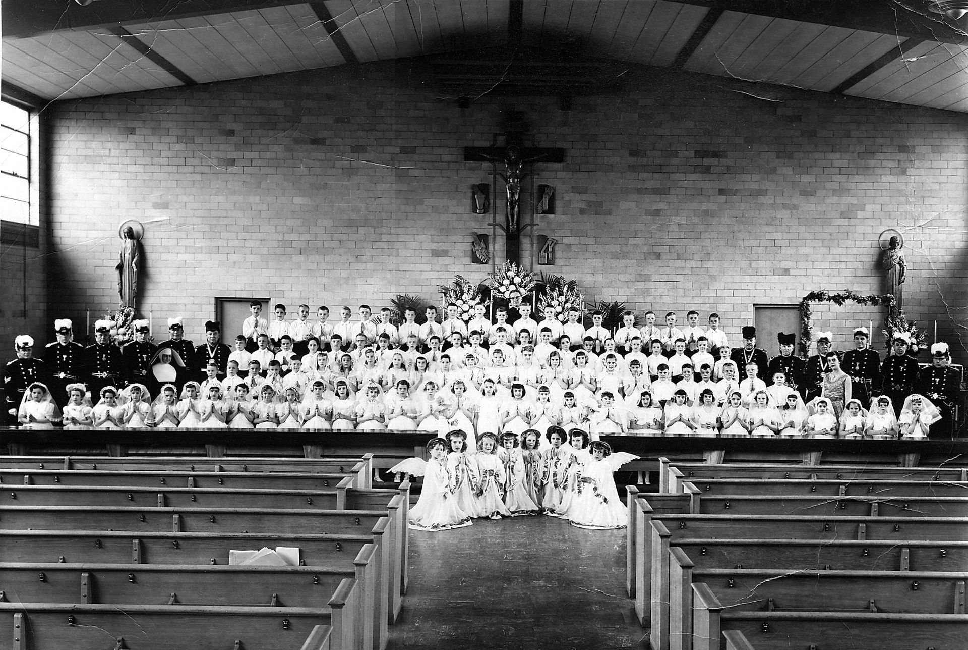 A black and white photo of people in a church