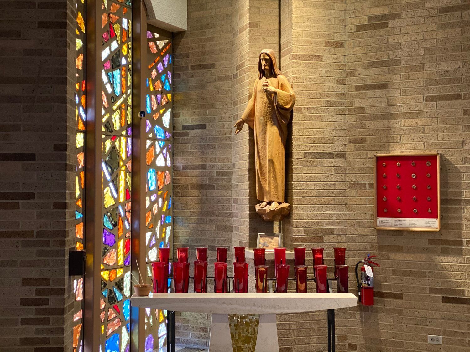 There is a statue of jesus on the altar in the church.