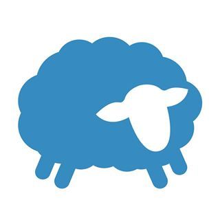 A blue sheep with a white head is standing on a white background.