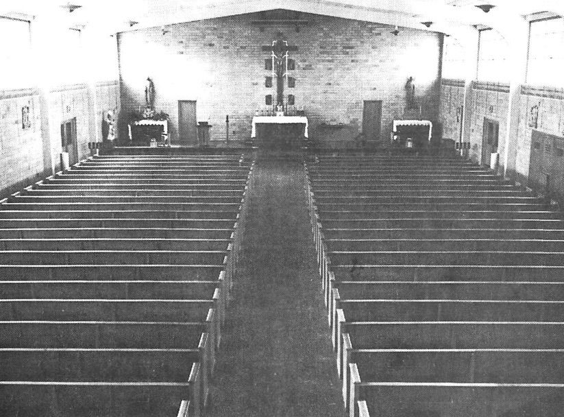 A black and white photo of an empty church