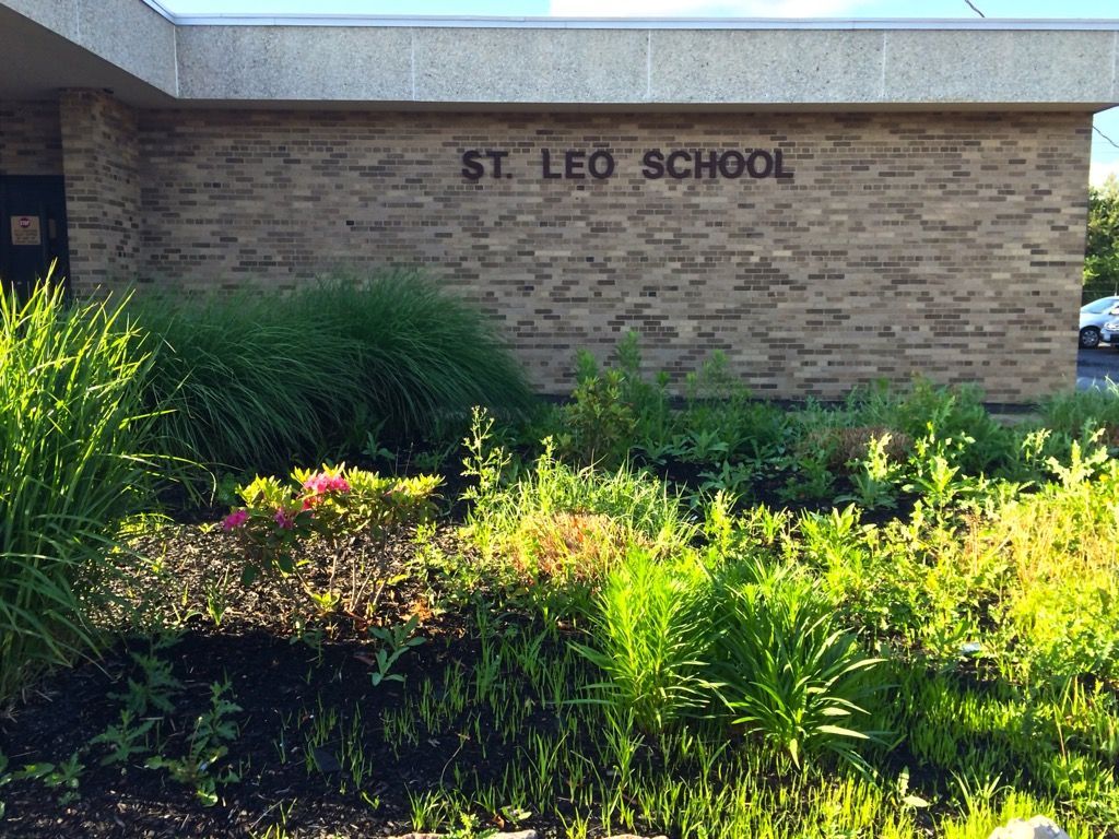 A brick building with a sign that says st. leo school