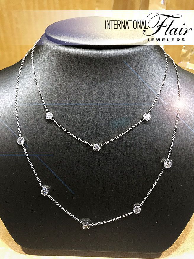 A necklace on a mannequin with the words international flair on the bottom