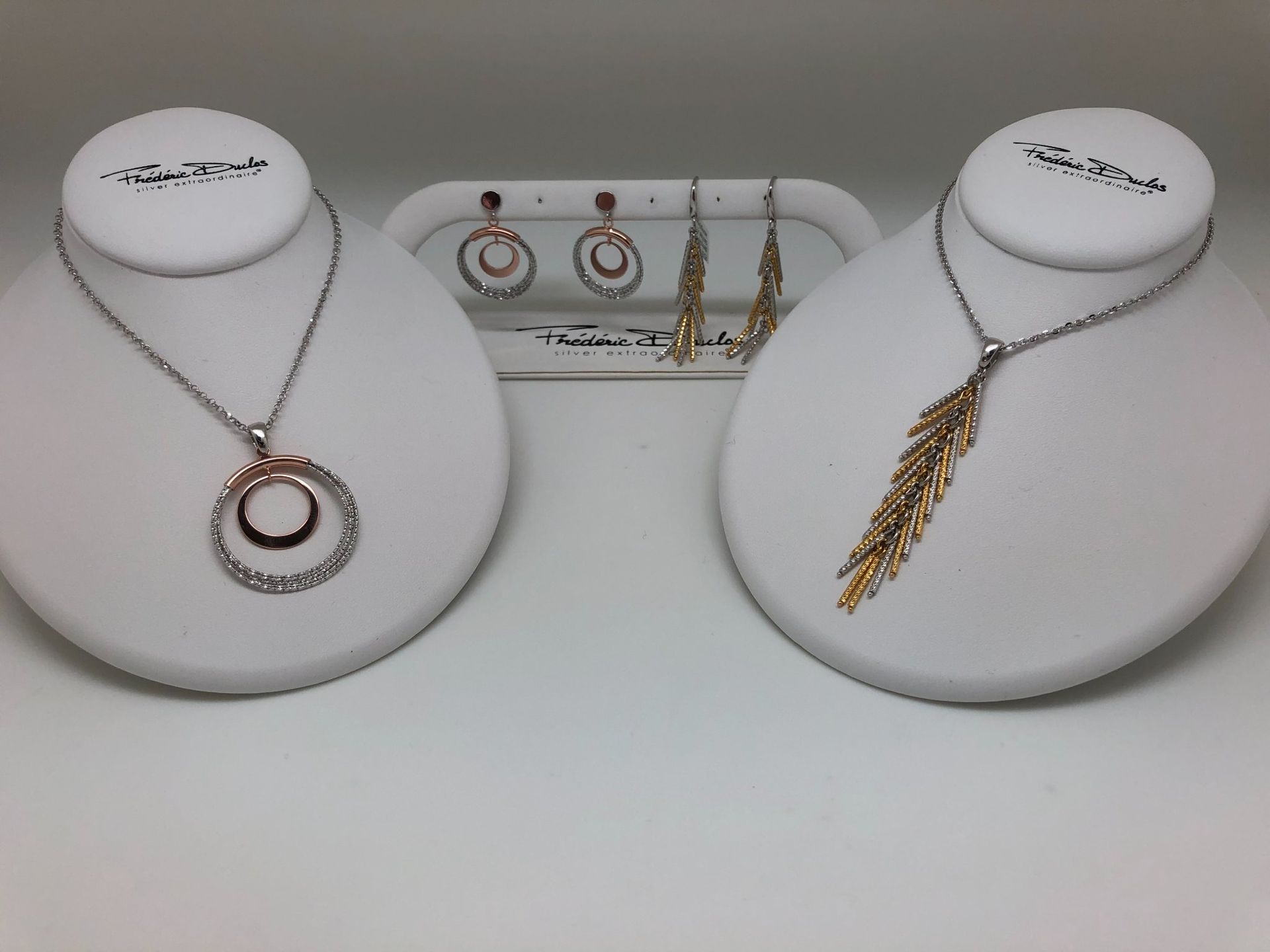 Two mannequins with necklaces and earrings on them