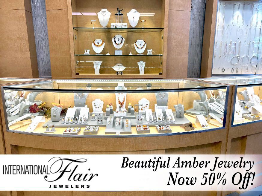 An advertisement for international flair jewelers says beautiful amber jewelry now 50 % off
