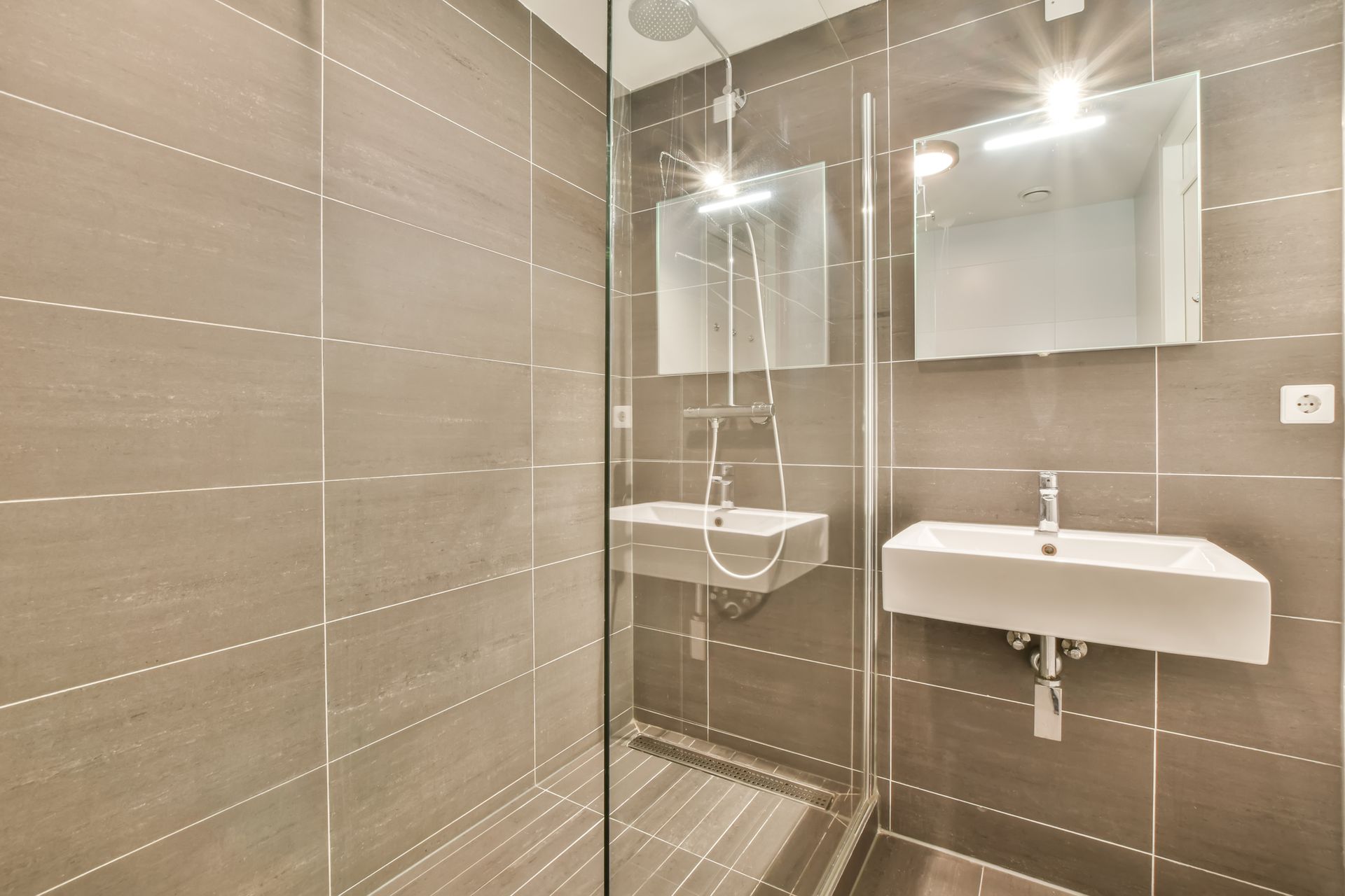 A beautiful bathroom with a modern interior and frameless shower doors.