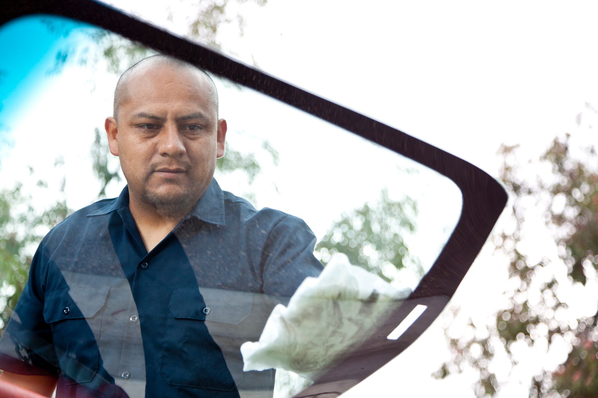 Auto service team showcasing local glass shop precision in glass replacement and repairs.