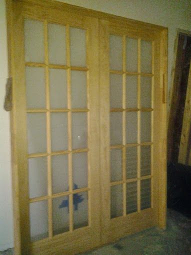 A pair of wooden sliding glass doors in a room.