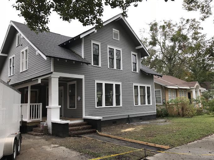 A house with a trailer parked in front of it,