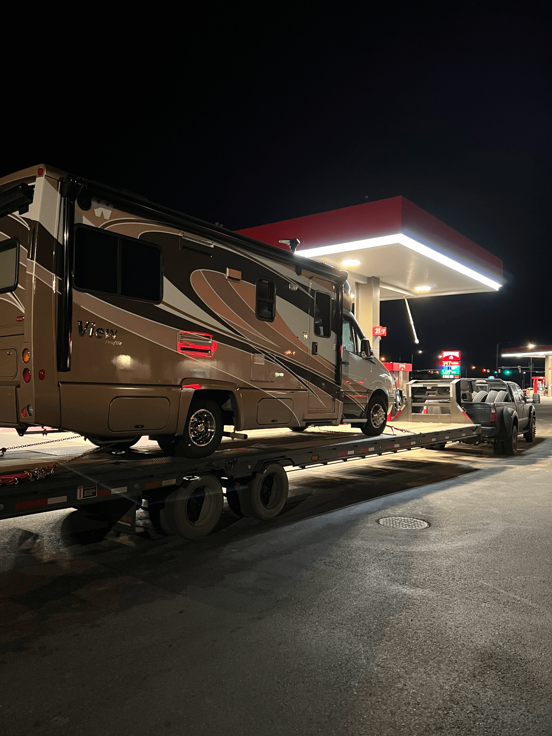 camper on haul3d flatbed trailer at gas station