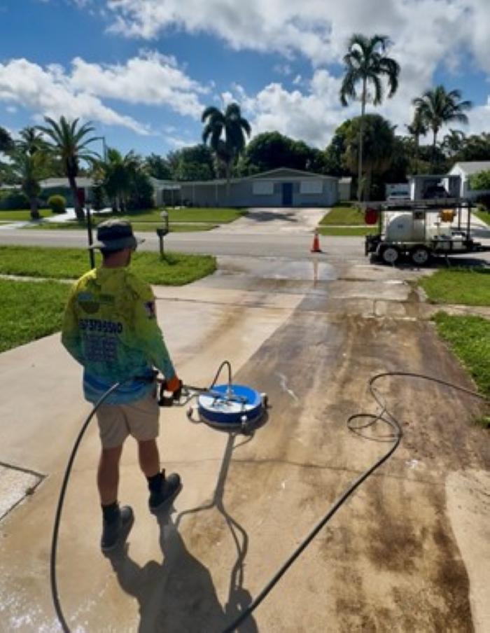 A white walkway leading to a swimming pool