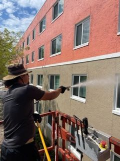 A tan truck is parked next to a white trailer