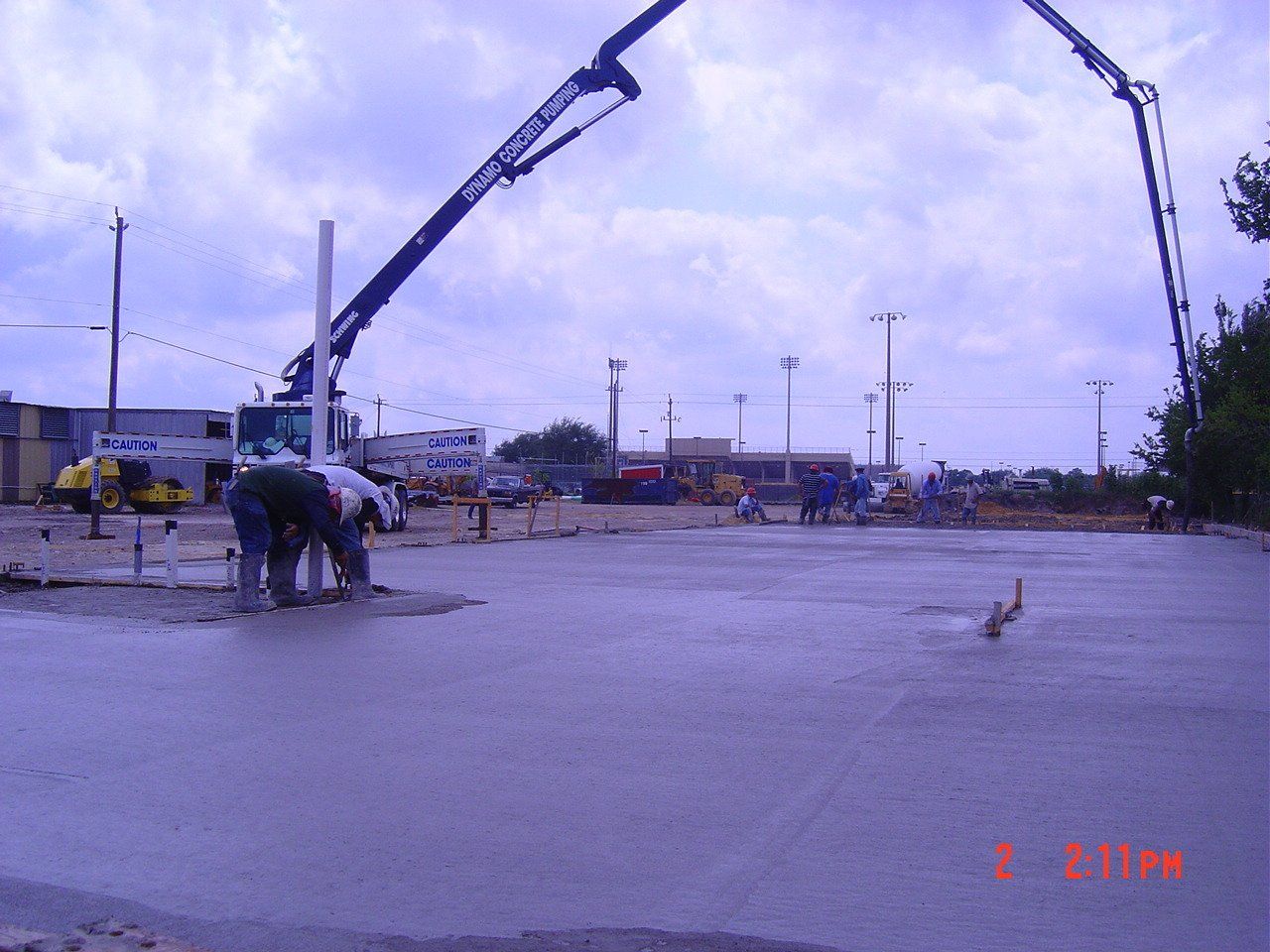 Construction workers smooth the concrete - Deer Park, TX - DH Construction