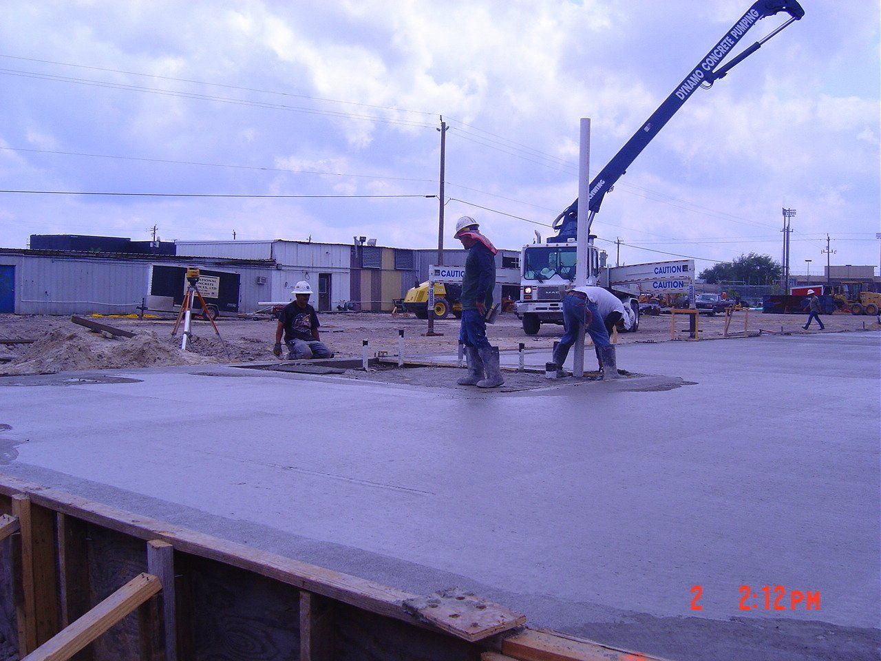 Workers smooth freshly poured concrete - Deer Park, TX - DH Construction
