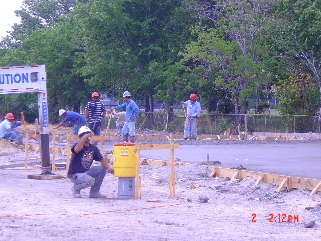 Concrete workers leveling road - Deer Park, TX - DH Construction