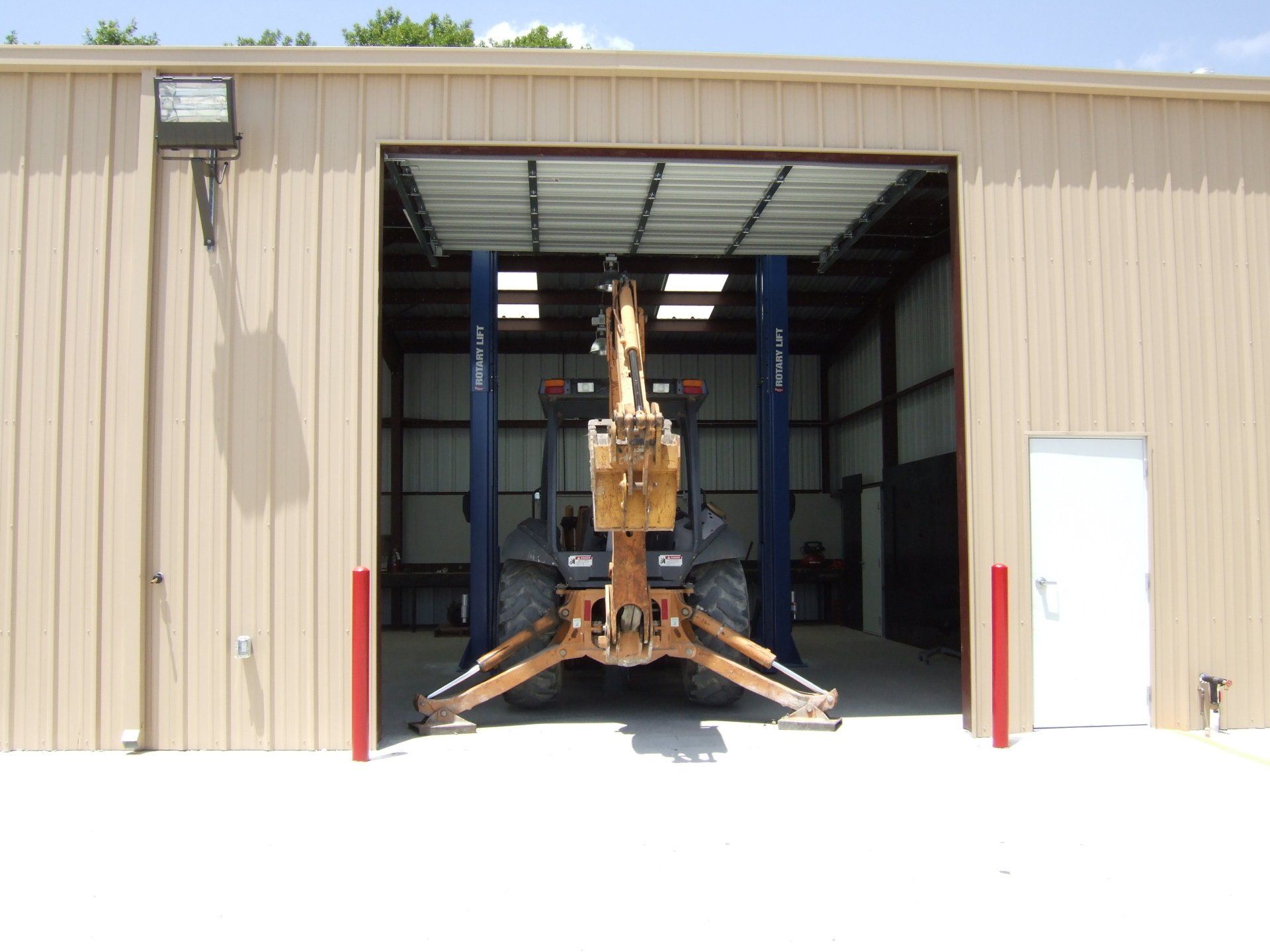 Tractor in front of warehouse - Deer Park, TX - DH Construction
