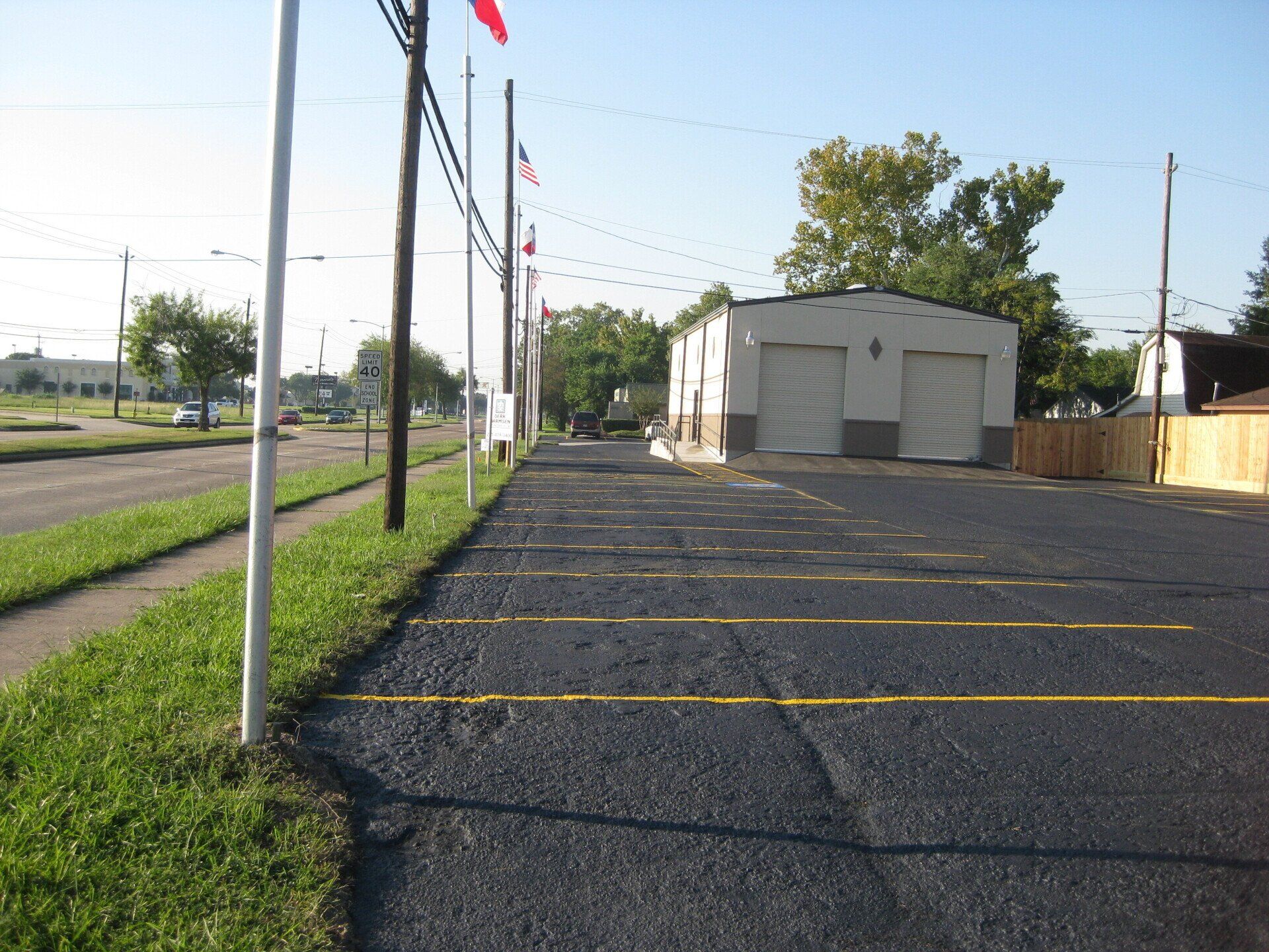 Asphalt parking lot near grassy sidewalk - Deer Park, TX - DH Construction