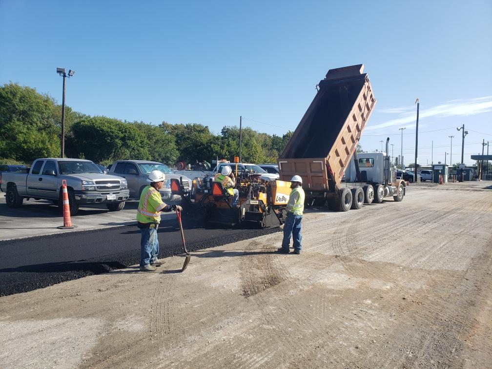 Workers paving parking area - Deer Park, TX - DH Construction