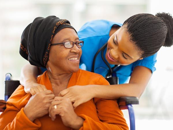 Home Assistance — Nurse and Patient on a Wheelchair in Upper Darby, PA