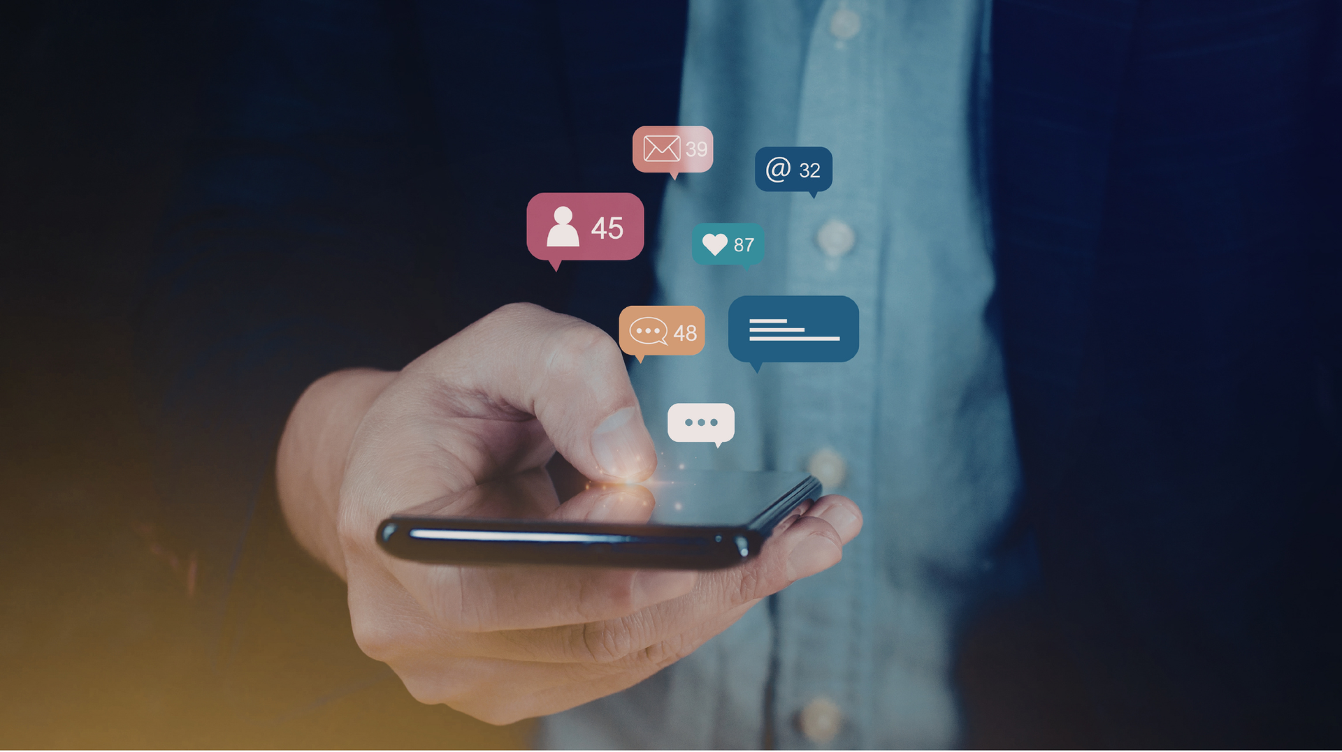 Hand holding a smartphone with floating social media notification icons above it