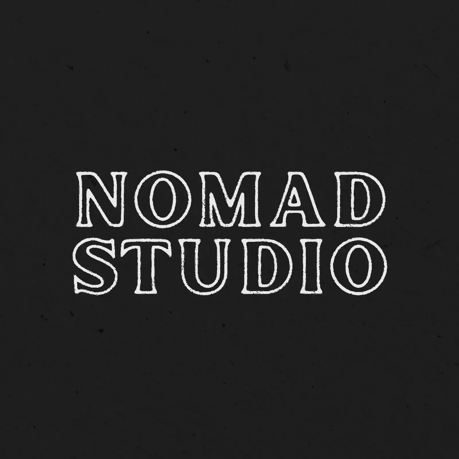 A black background with white text that says nomad studio showing example of a logo design.