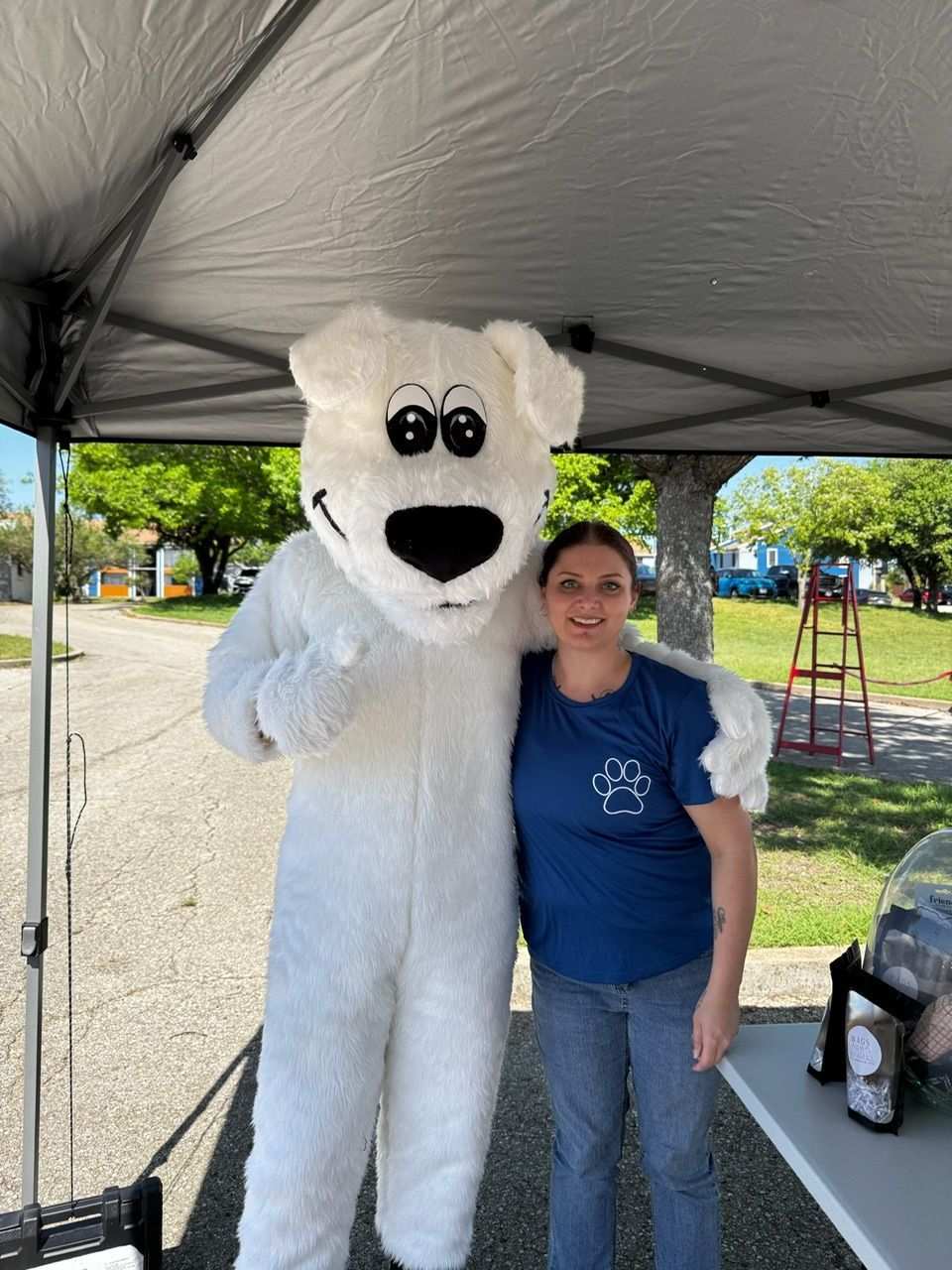 Woman Is Standing Next to A Polar Bear Mascot — Temple, TX — Wags On Wheels
