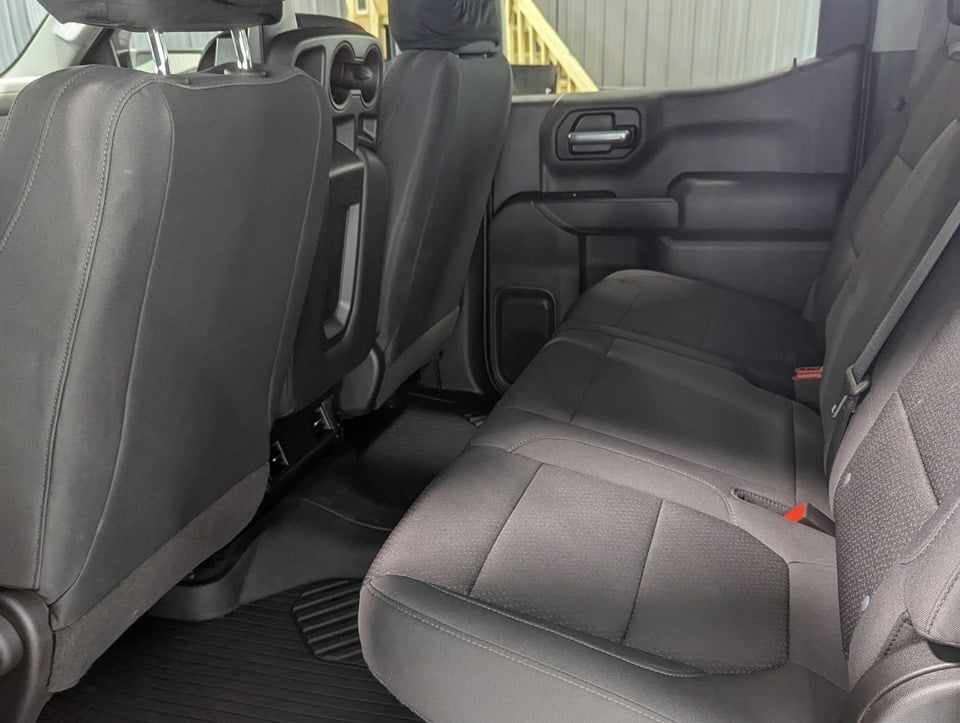 The back seat of a truck with a staircase in the background.