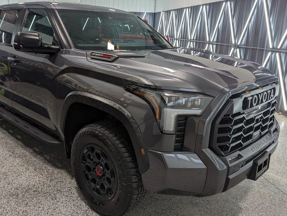A toyota tundra is parked in a showroom.