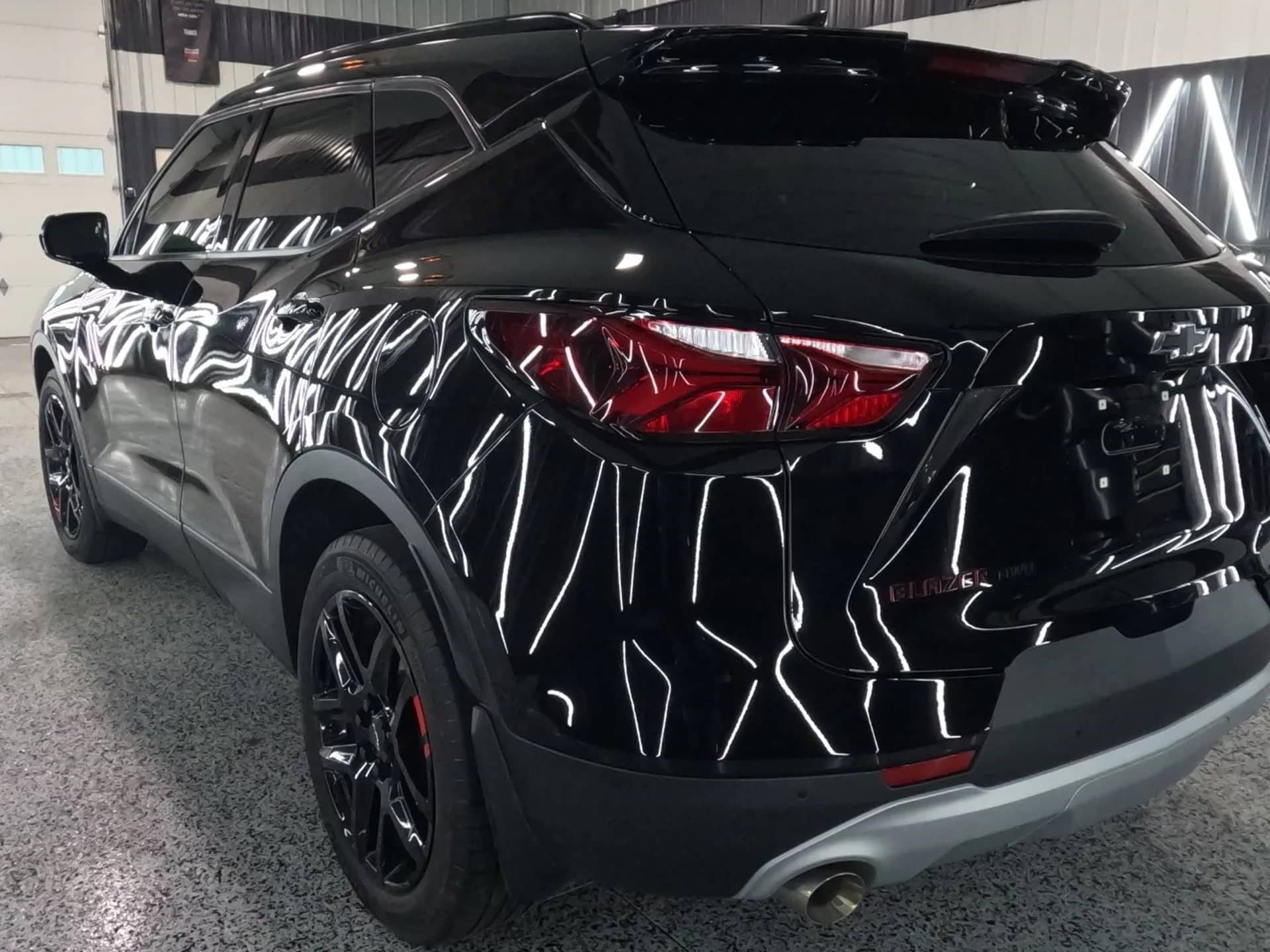 A black suv is parked in a garage