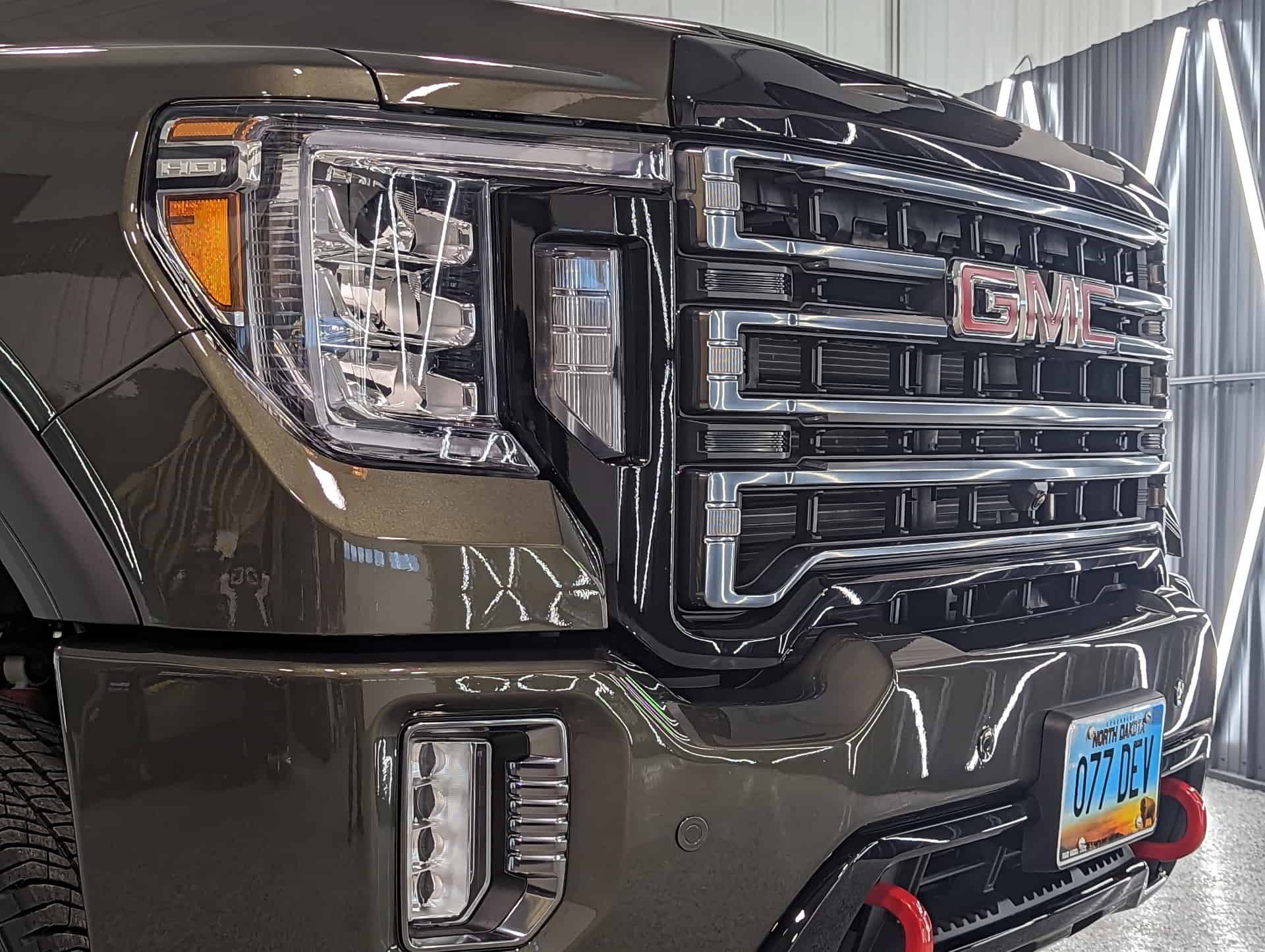 A gmc truck is parked in a garage.