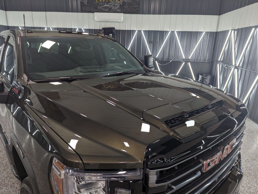 A gmc truck is parked in a garage.