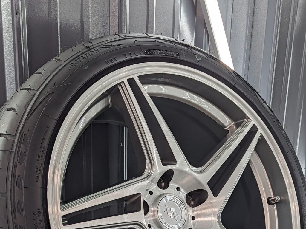 A close up of a car wheel with a tire on it.