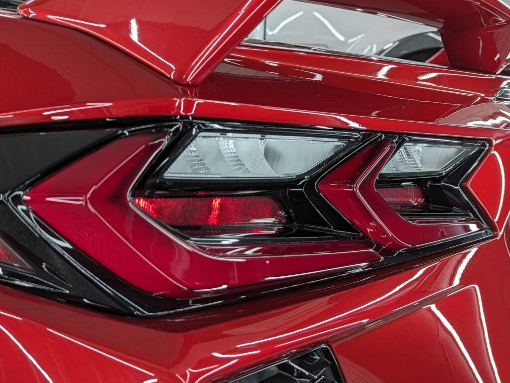 A close up of a red car 's tail light