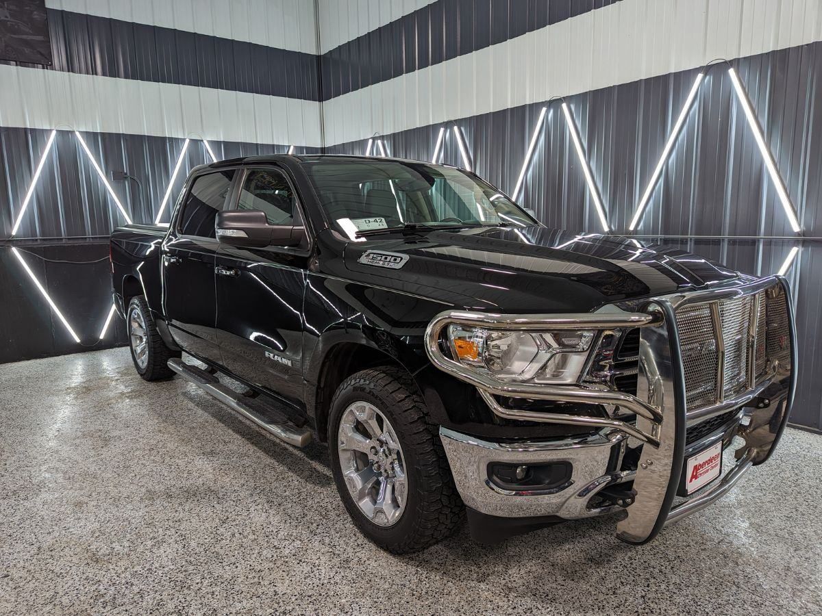 A black dodge ram truck is parked in a garage.