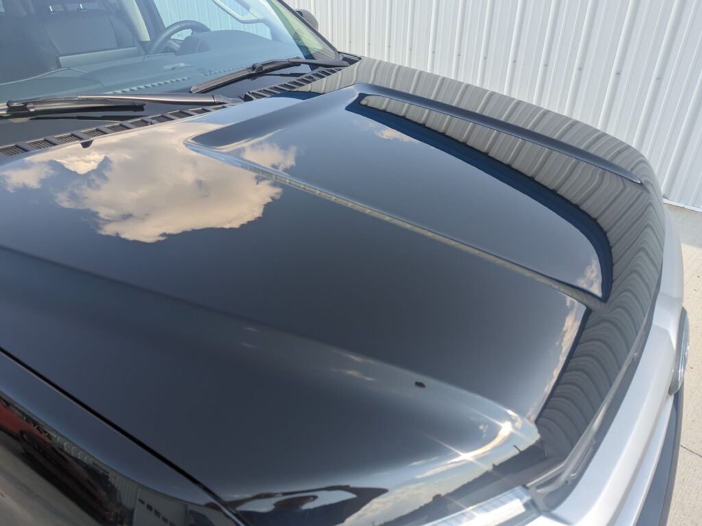 A close up of the hood of a black car